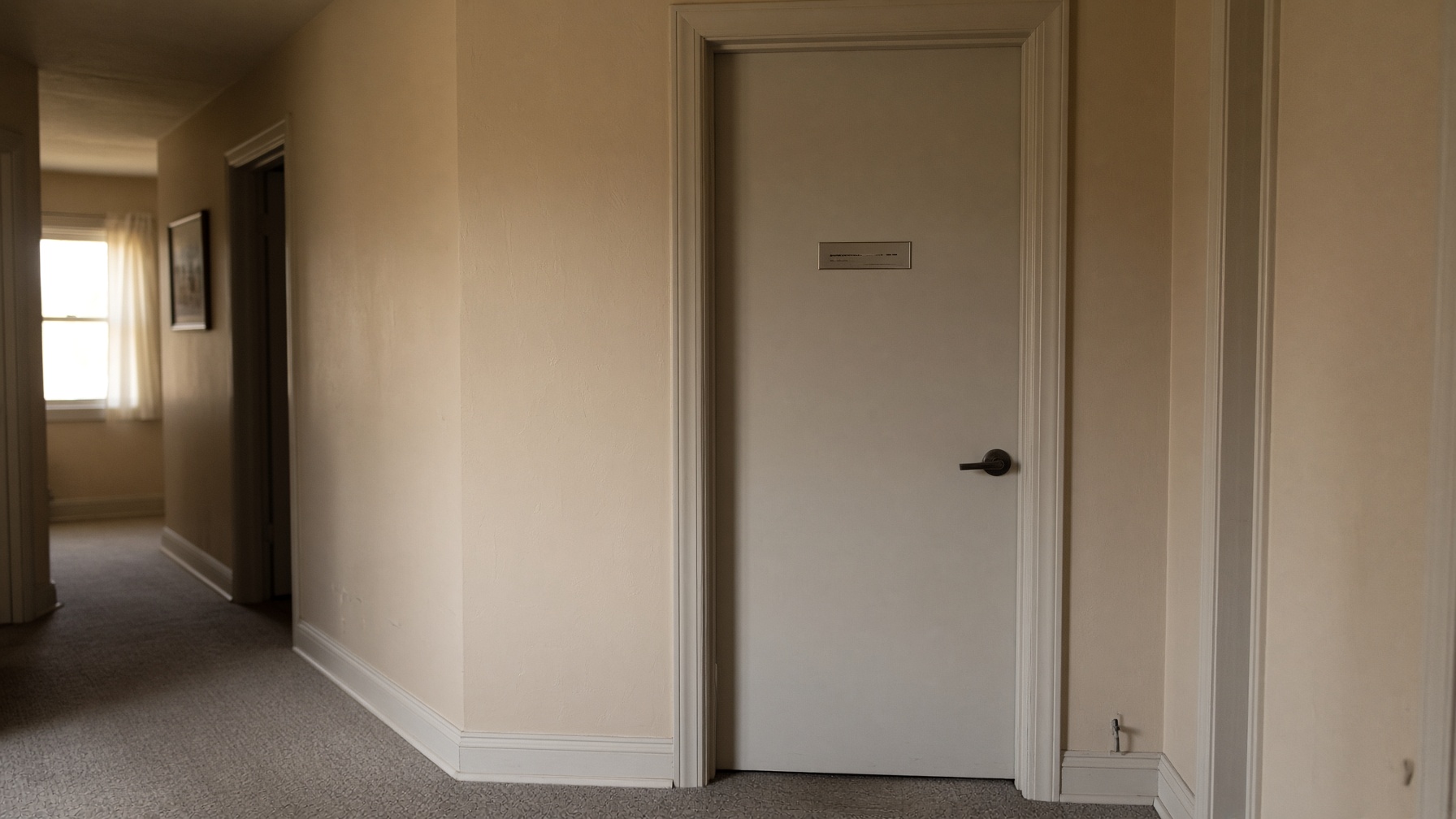 A closed bedroom door in a residential hallway — privacy that may or may not be honored.