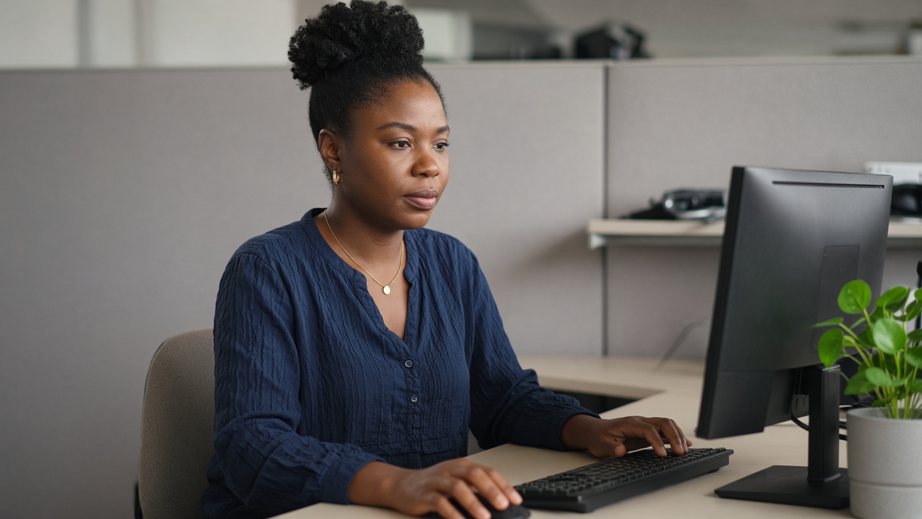 A woman working at a desk in an office.