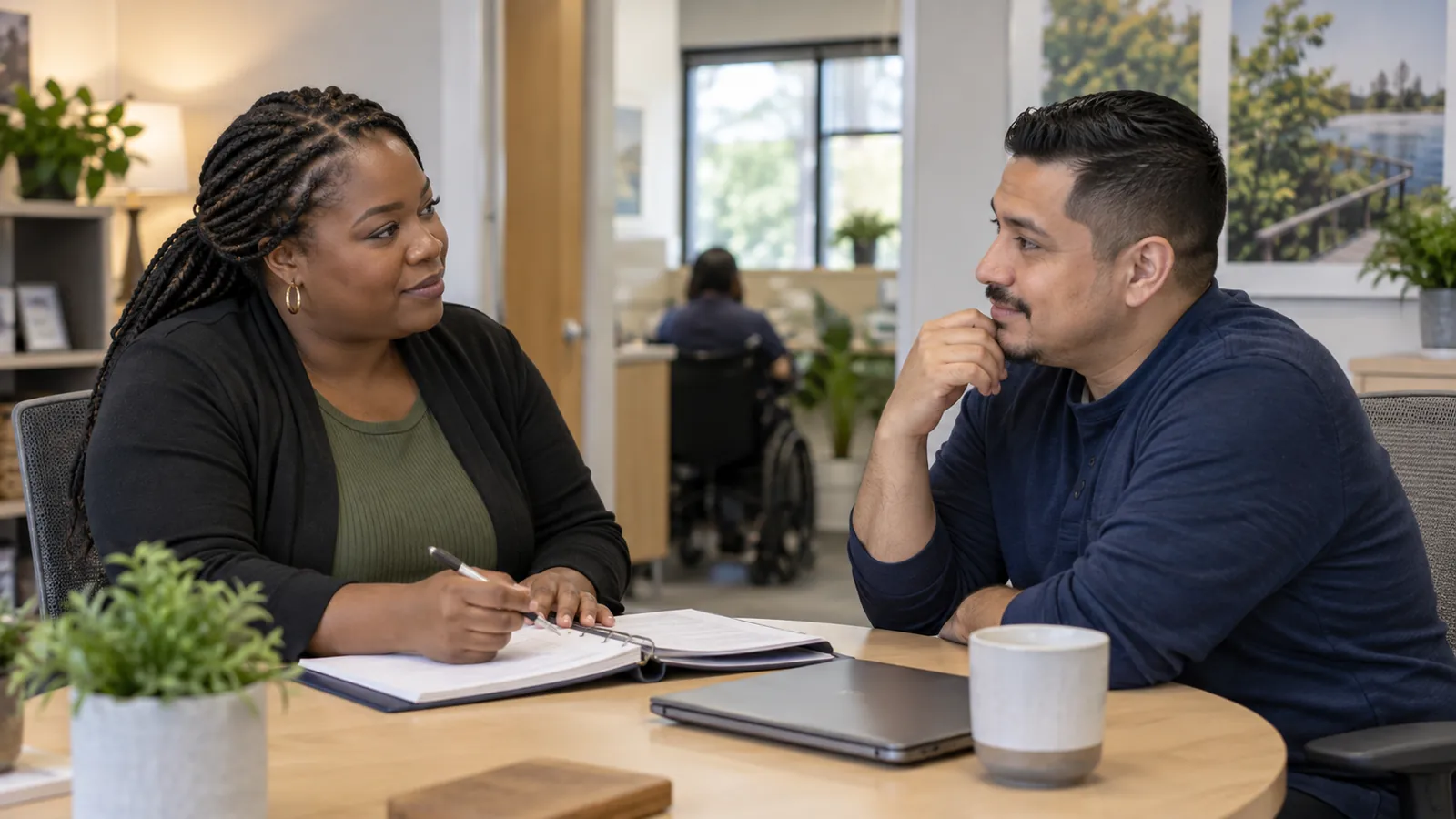 A supervisor listens to a colleague during a one-to-one conversation.