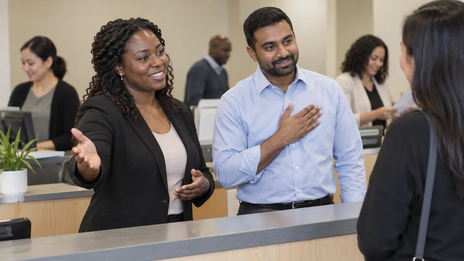 Two colleagues exchange perspectives in a public-service office.