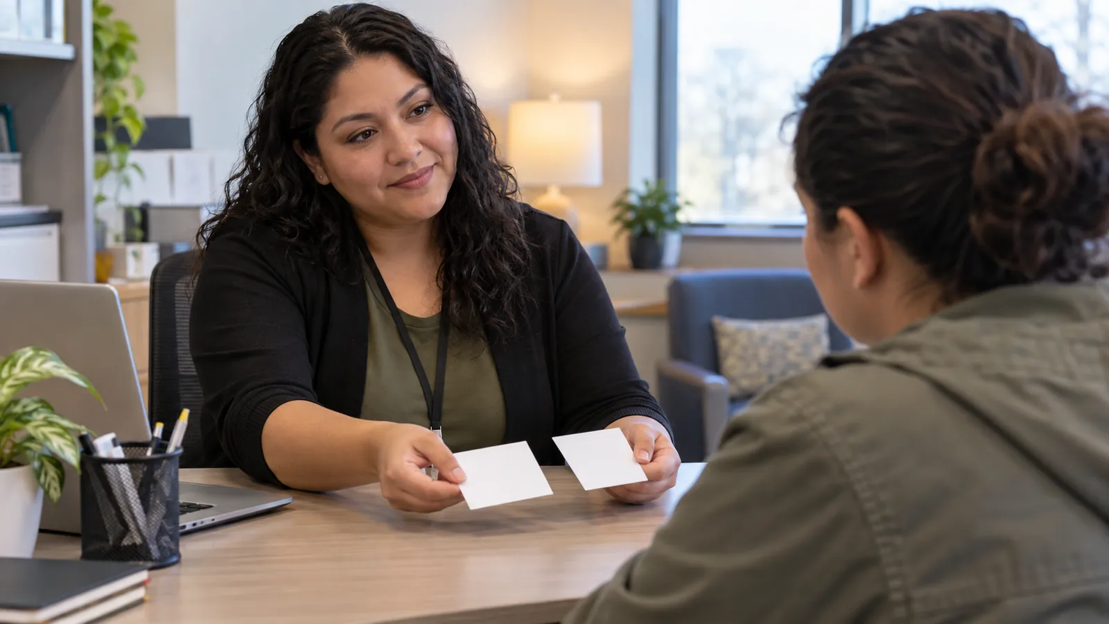 A navigator offers a visitor two appointment options in a calm office.