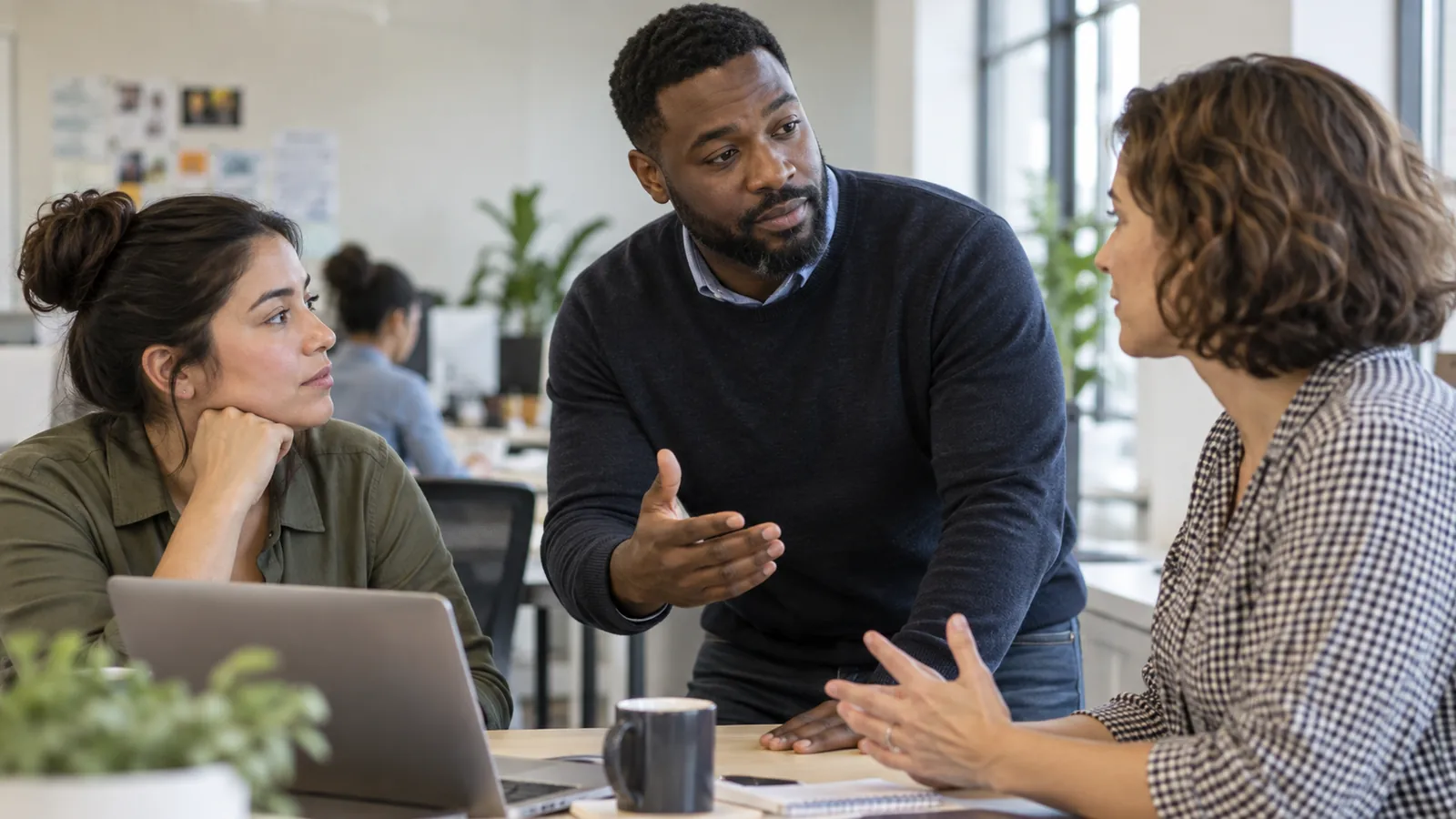 Three colleagues practice a thoughtful response in a workplace conversation.