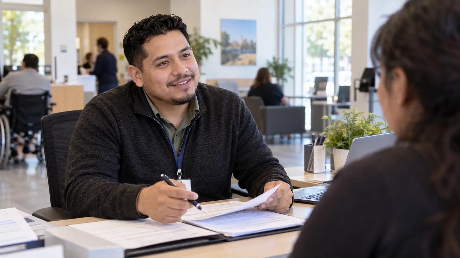 A professional reviews documents at a public-service desk.
