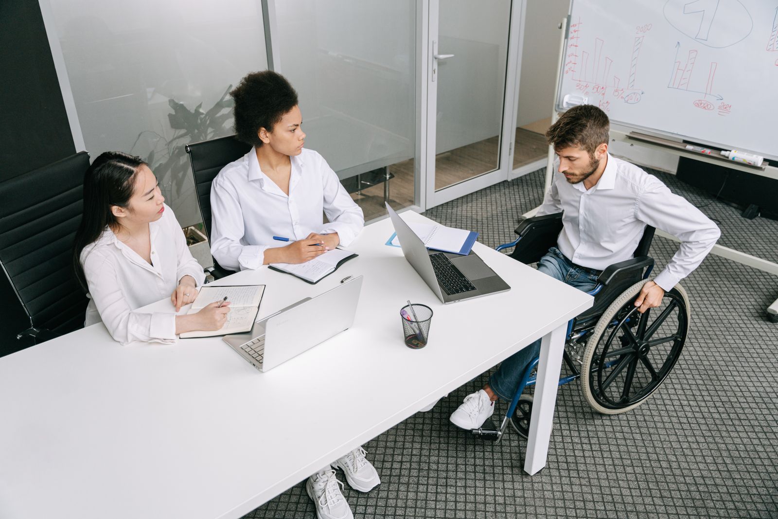 A large group of colleagues seated around a conference table for a meeting.